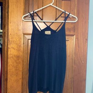 Cute tank with intricate straps.